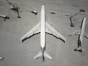 Aerial view of cargo planes at an airport with loading equipment.