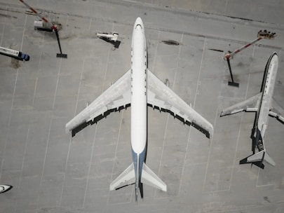 Aerial view of cargo planes at an airport with loading equipment.