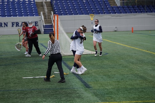 Players in north carolina blue jerseys celebrating a game-winning basket on the court.