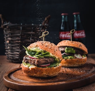 burger with vegetable on brown wooden tray