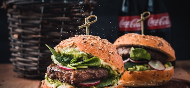 burger with vegetable on brown wooden tray