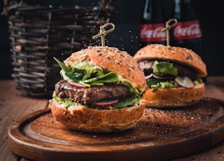 burger with vegetable on brown wooden tray