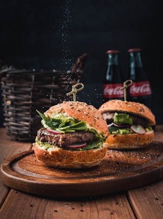 burger with vegetable on brown wooden tray