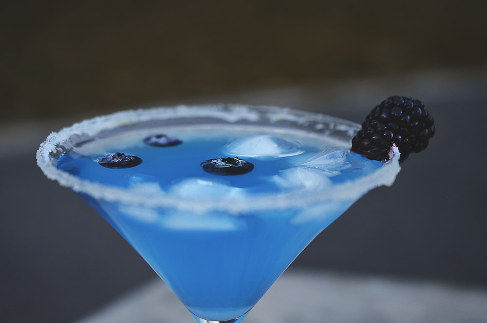 blue liquid in martini glass