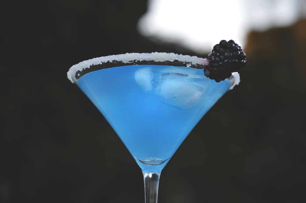 blue liquid on long stem drinking glass