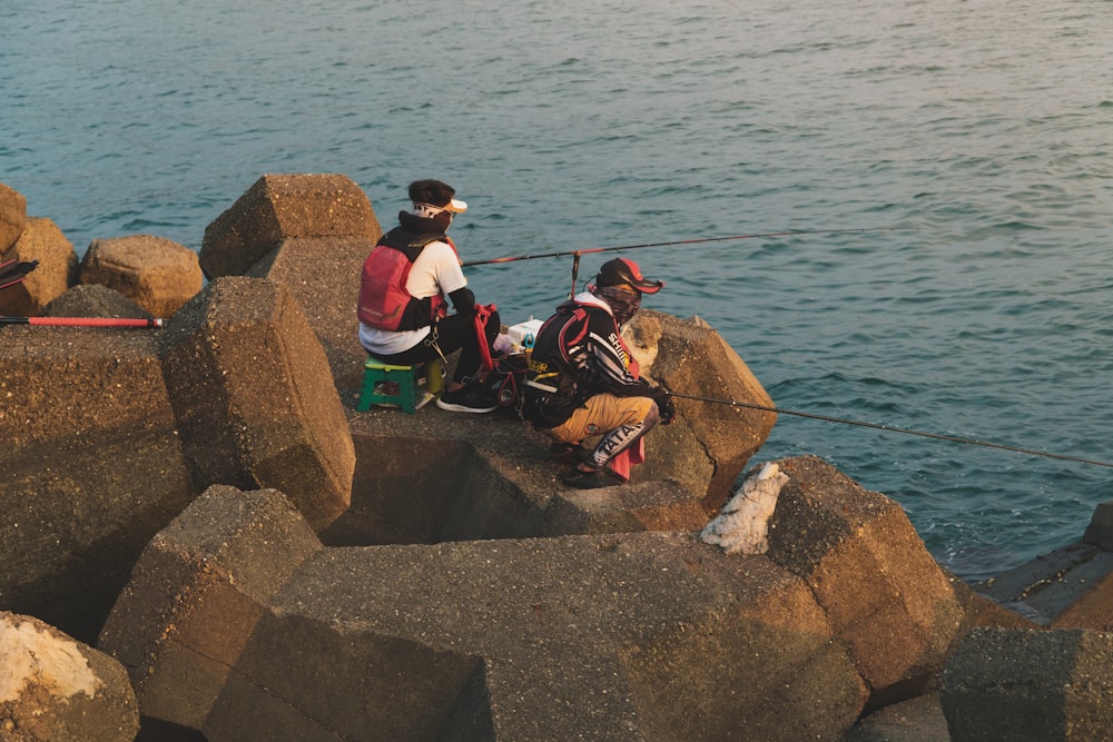 two men fishing on sea