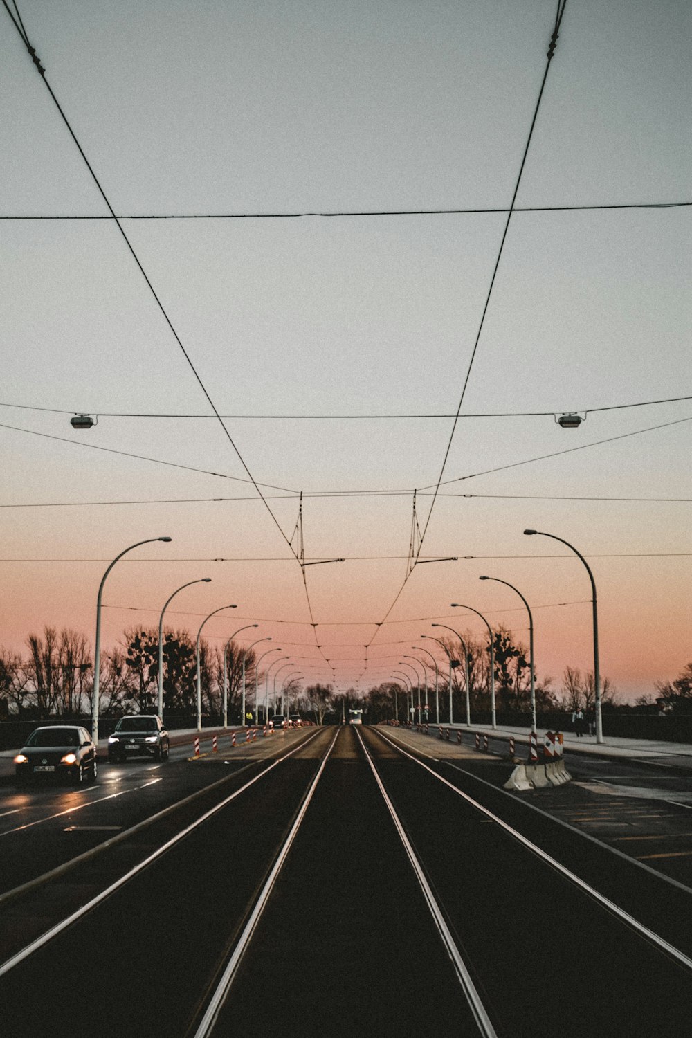 vehicles on gray concrete road under gray sky