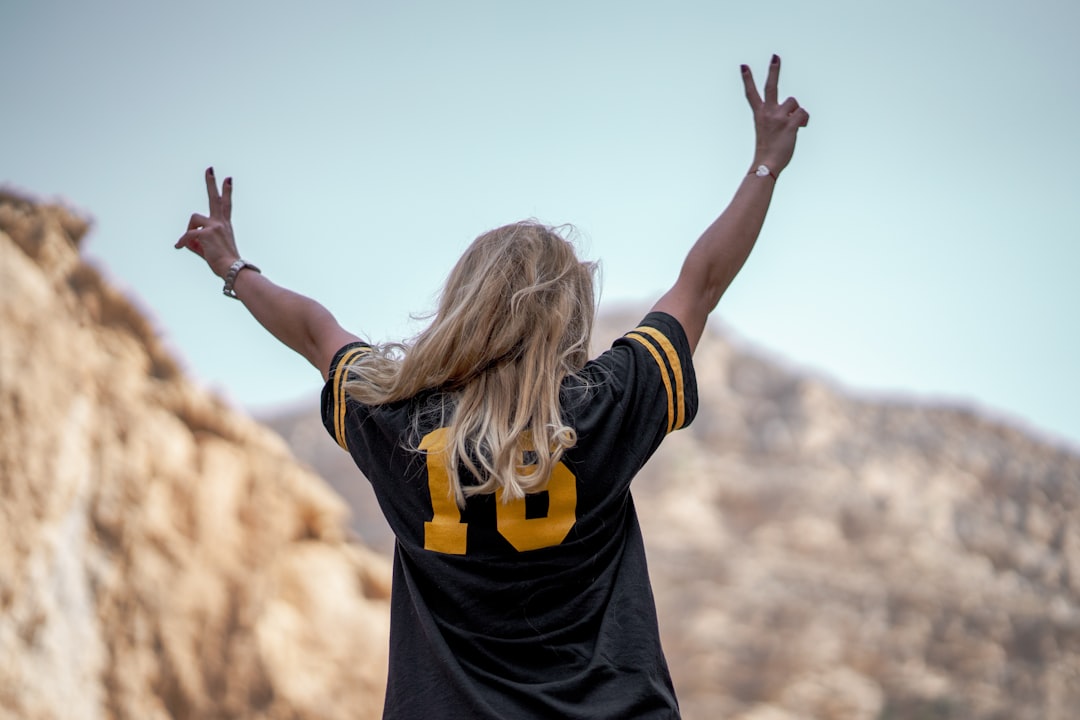 woman standing on top of mountain during daytime