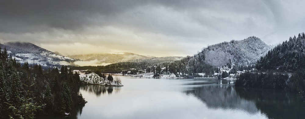 body of water between mountain during daytime