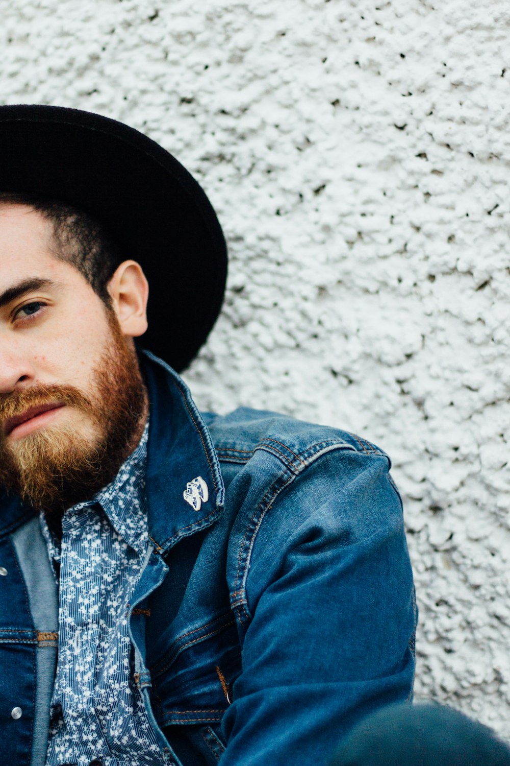 man wearing blue denim jacket