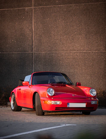 Stylish metal wall art depicting a classic sports car with polished chrome highlights and rich color saturation.