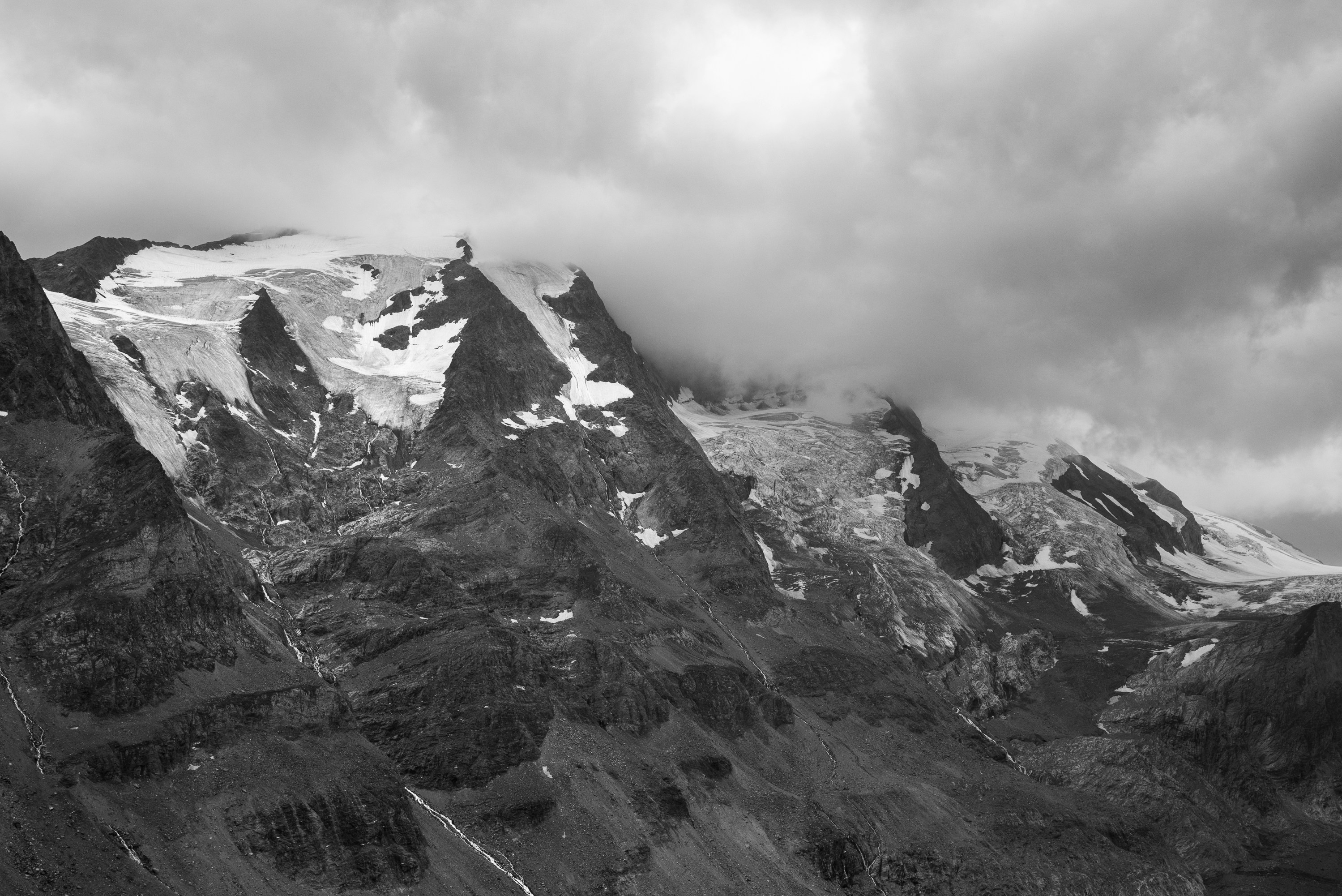 snow-capped mountain under dark clouds