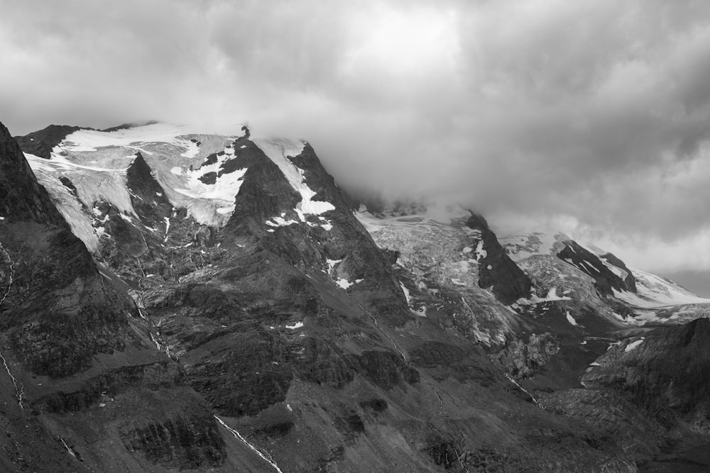 snow-capped mountain under dark clouds