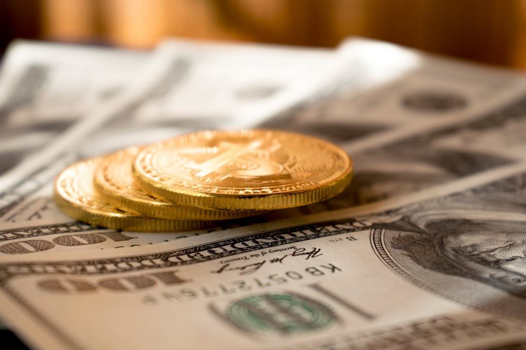 A close-up image of hands exchanging cash with a blurred background, suggesting a concept of sending money or a financial transaction.