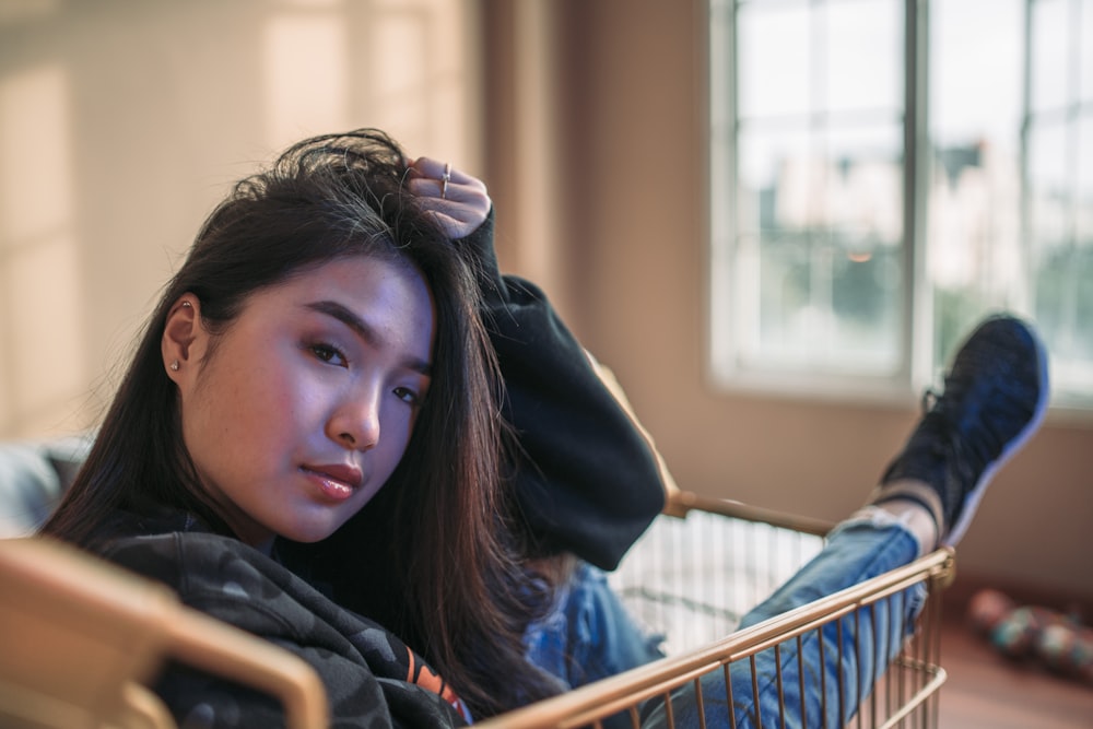 shallow focus photo of woman riding shopping cart