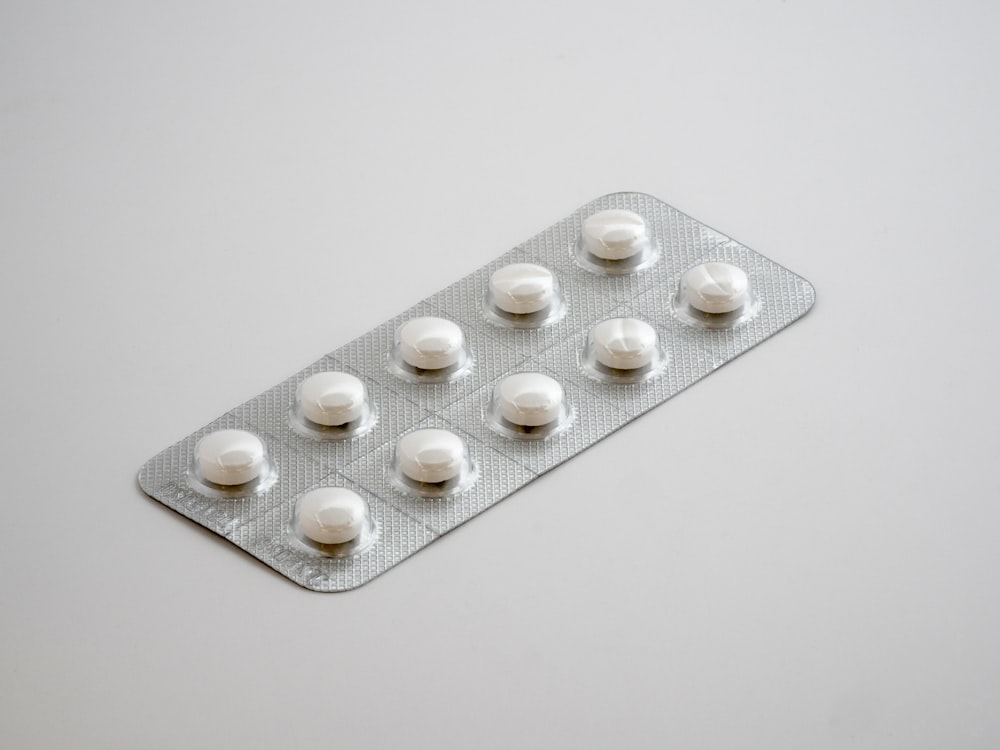 gray blister pack on white surface