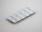 gray blister pack on white surface