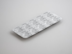 gray blister pack on white surface