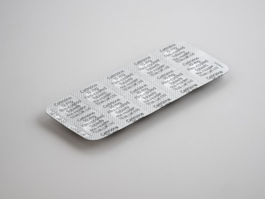 gray blister pack on white surface