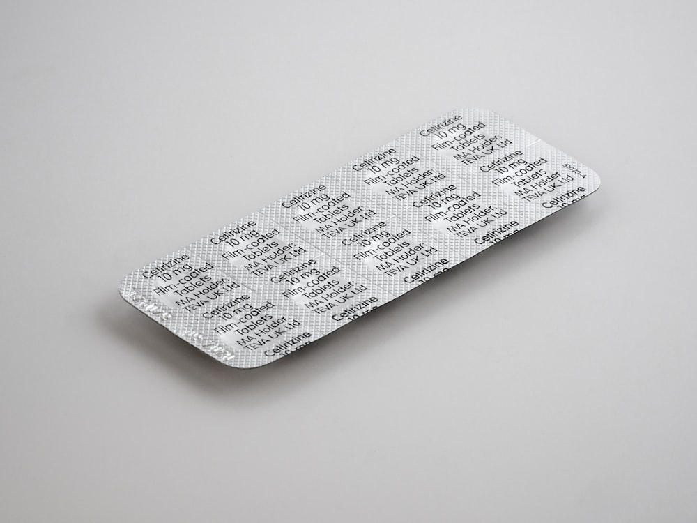 gray blister pack on white surface