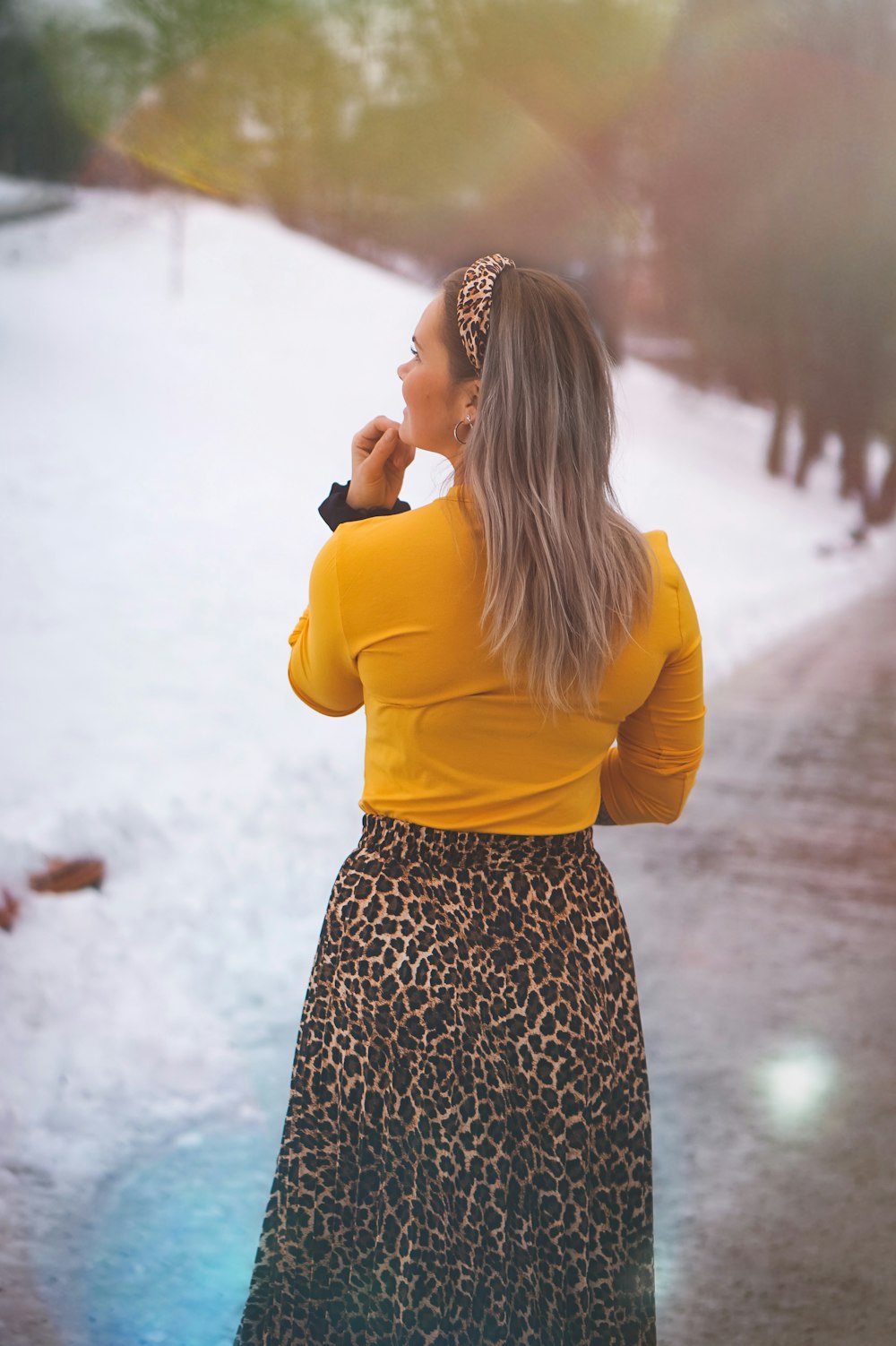 woman wearing yellow long-sleeved dress standing at daytime