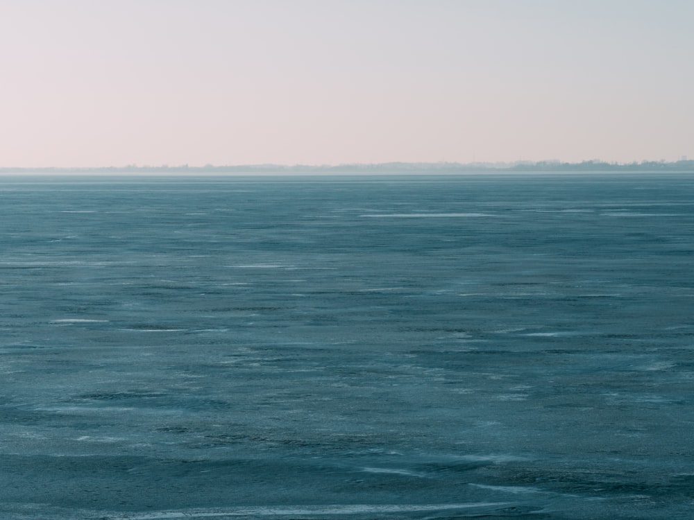 body of water under clear blue sky