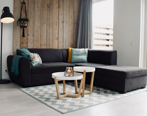 light candle on round white coffee table and sectional sofa