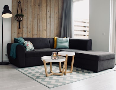 light candle on round white coffee table and sectional sofa