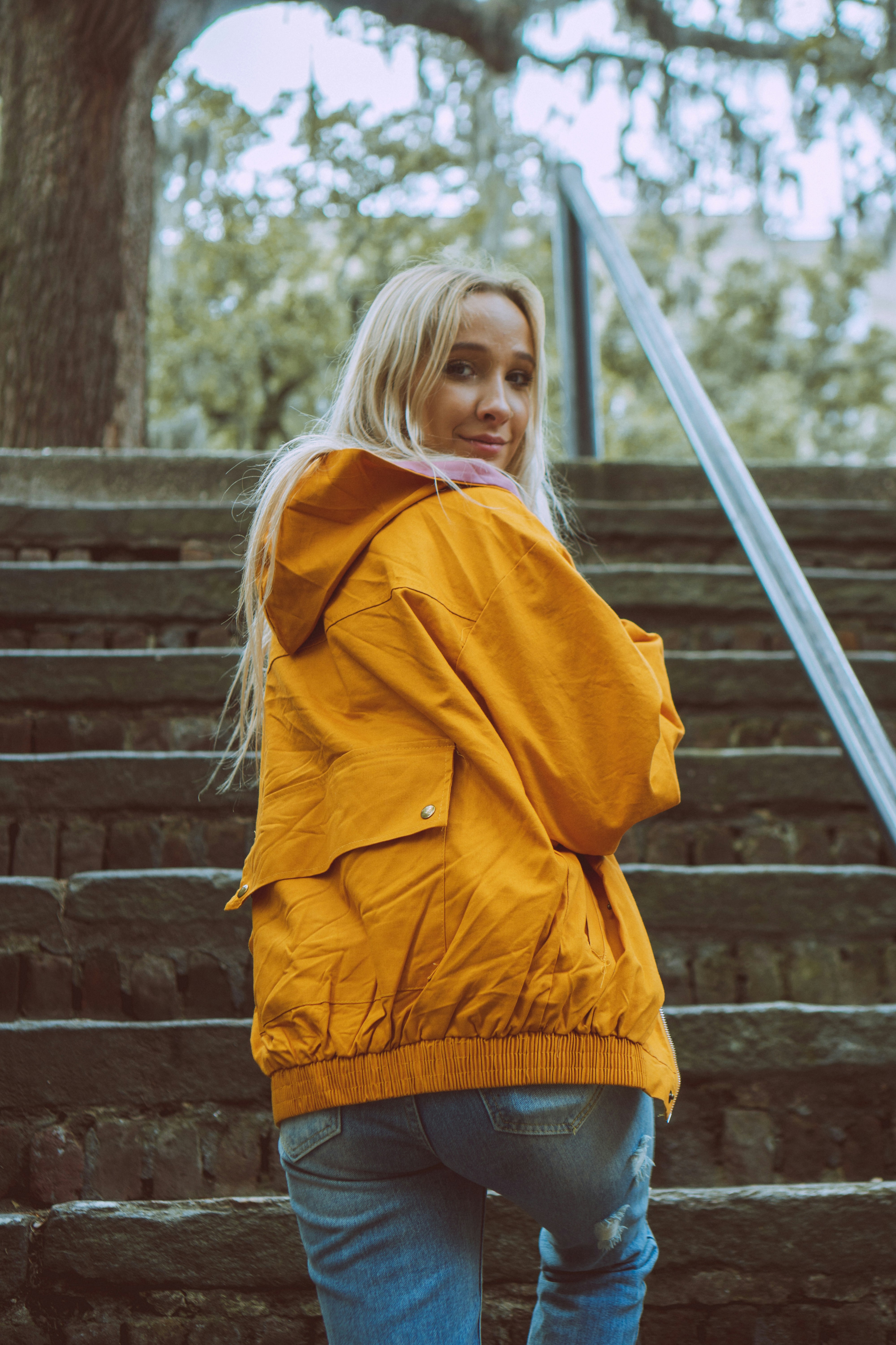 Woman climbing stairs and looking backwards photo Free Clothing Image