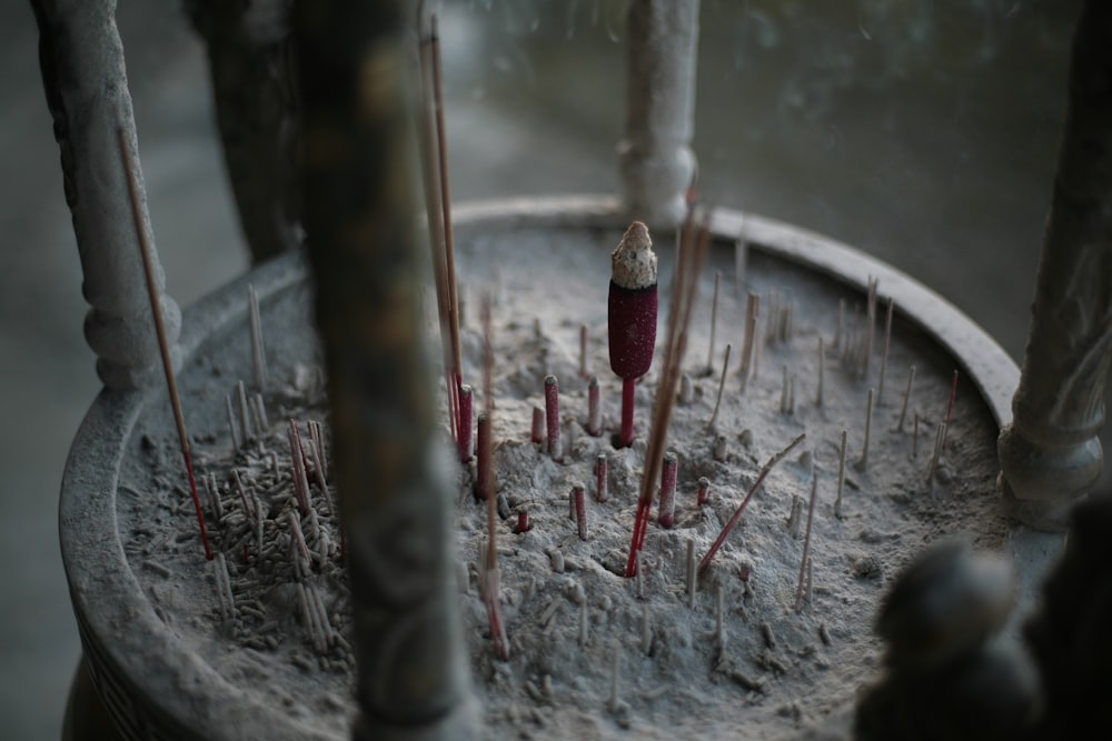 red incense candles on gray container