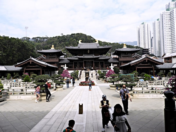Pilgrims visiting a serene temple surrounded by lush greenery.