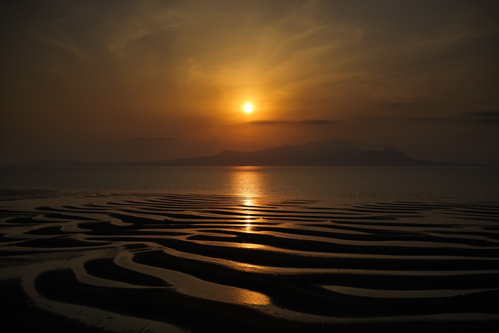 ocean and island during sunset