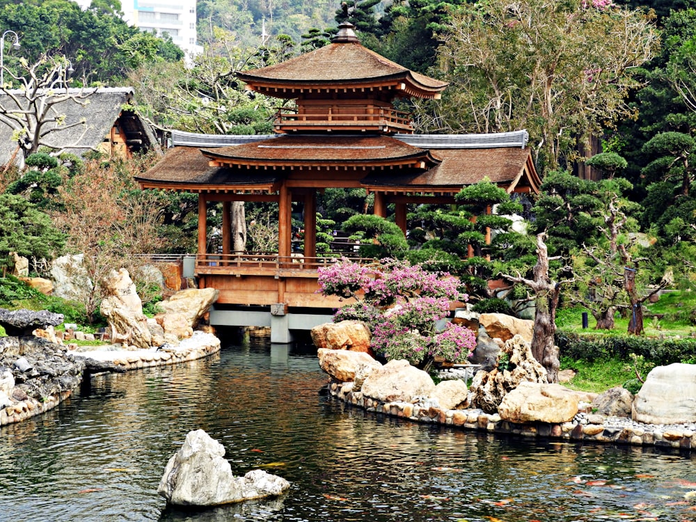 brown wooden temple near pond