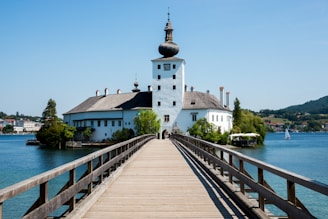 photo of white and brown mosque and pier
