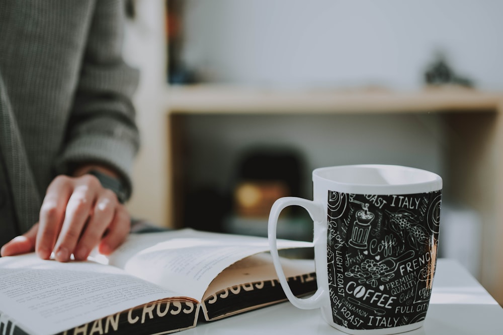 shallow focus photo of white and black ceramic mug