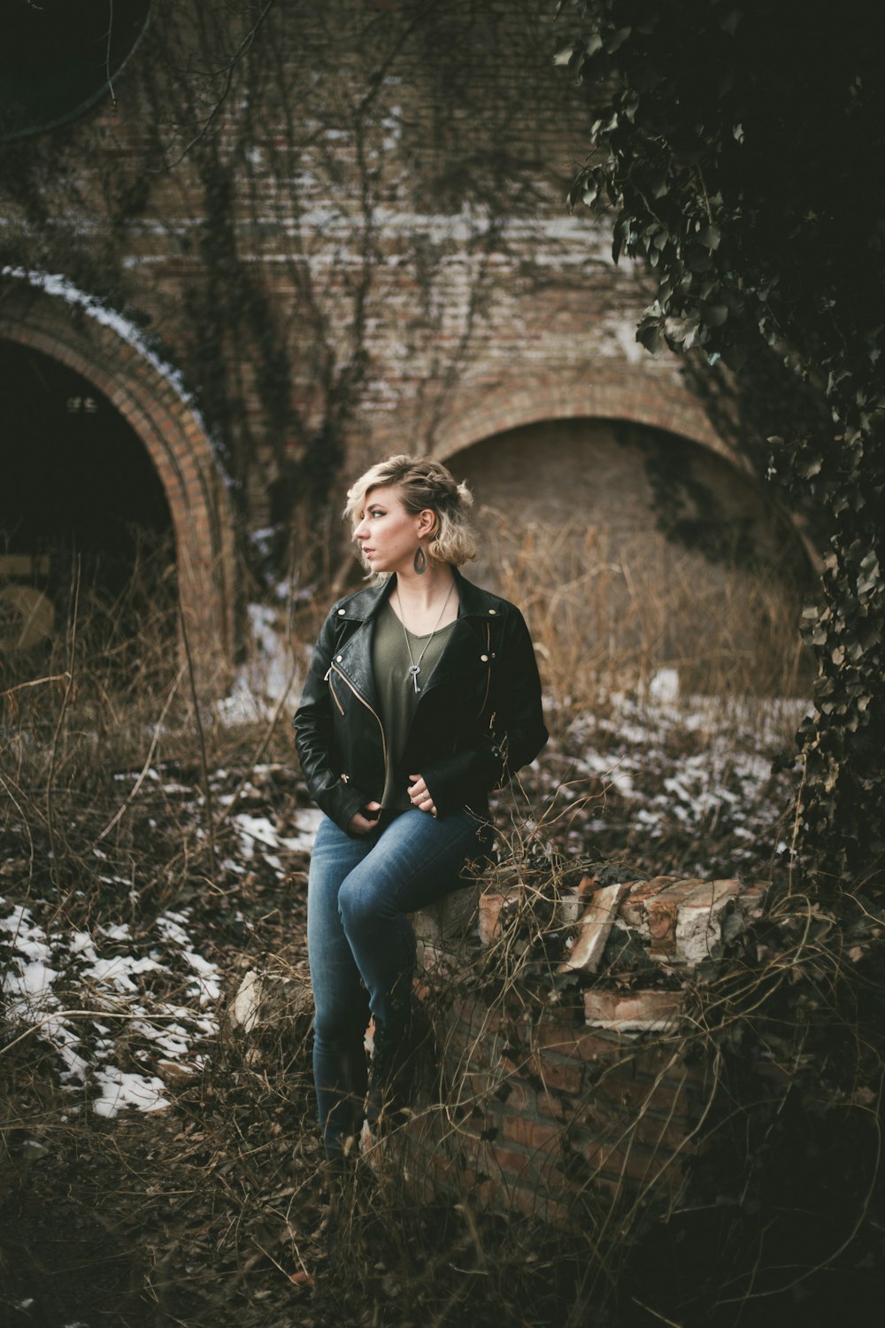 woman sitting surrounded by brances