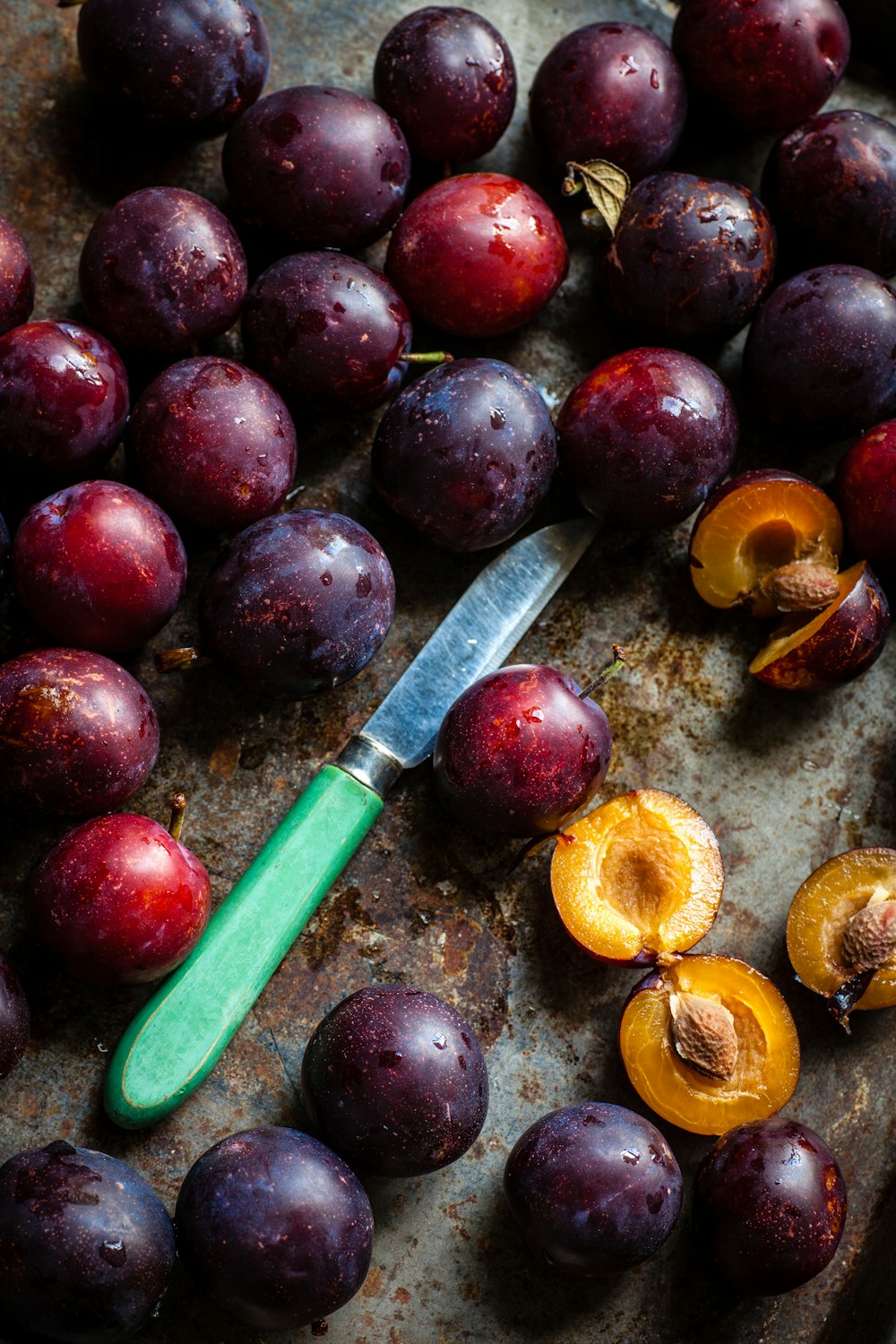 green knife surrounding of fruits