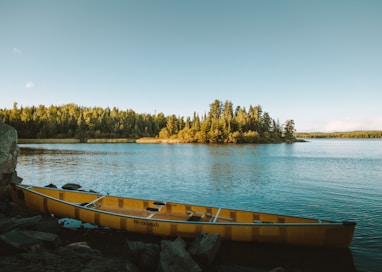 yellow canoe on body of water