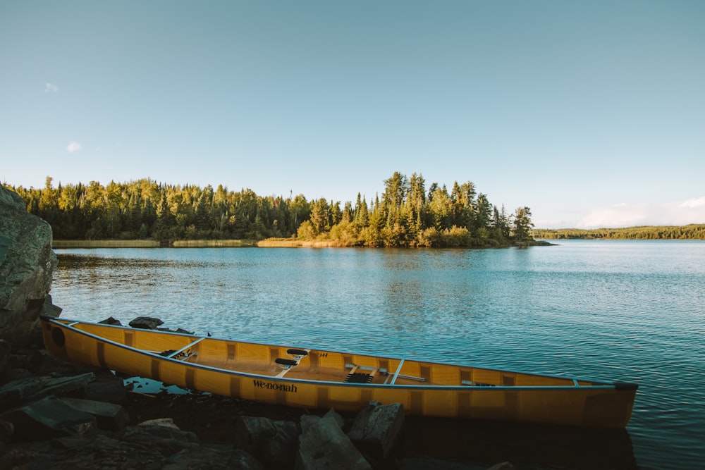 yellow canoe on body of water