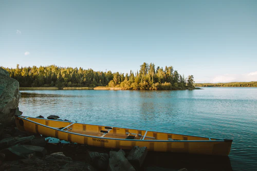Yellow canoe resting on a calm Minnesota lake, reflecting the outdoor pace of dating across the state