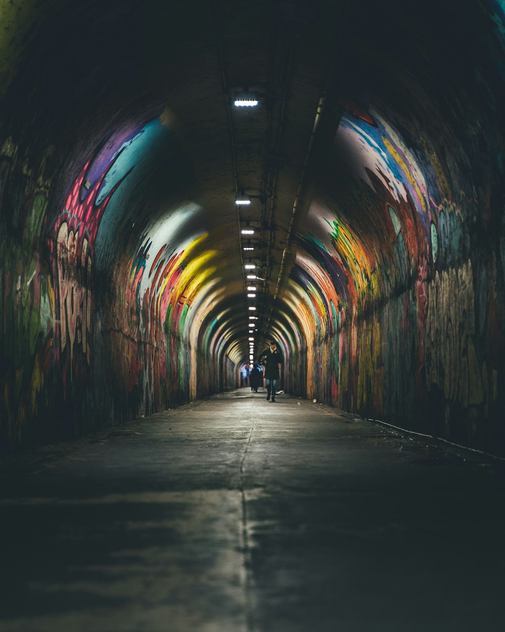 person walking in tunnel