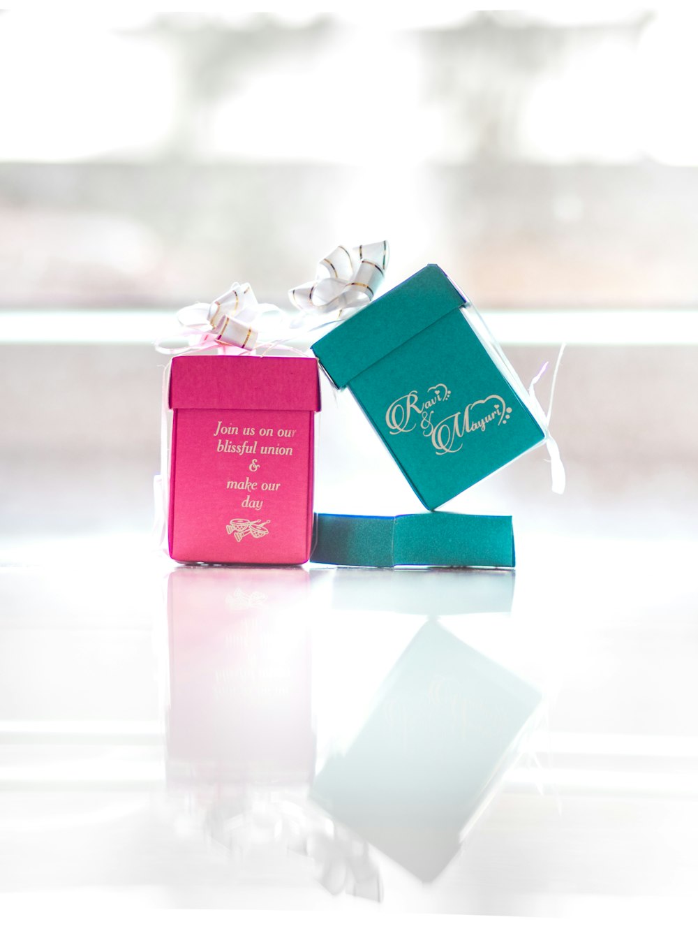 two pink and teal ring boxes