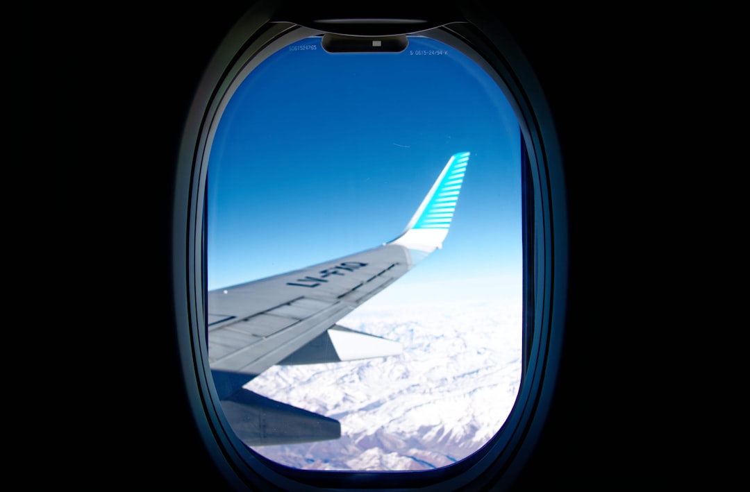 white airplane wing viewed over window