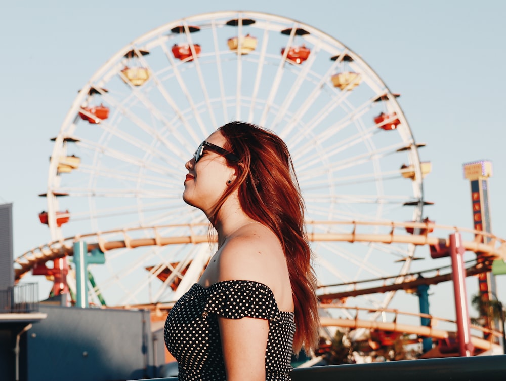 woman standing near ferris wheel