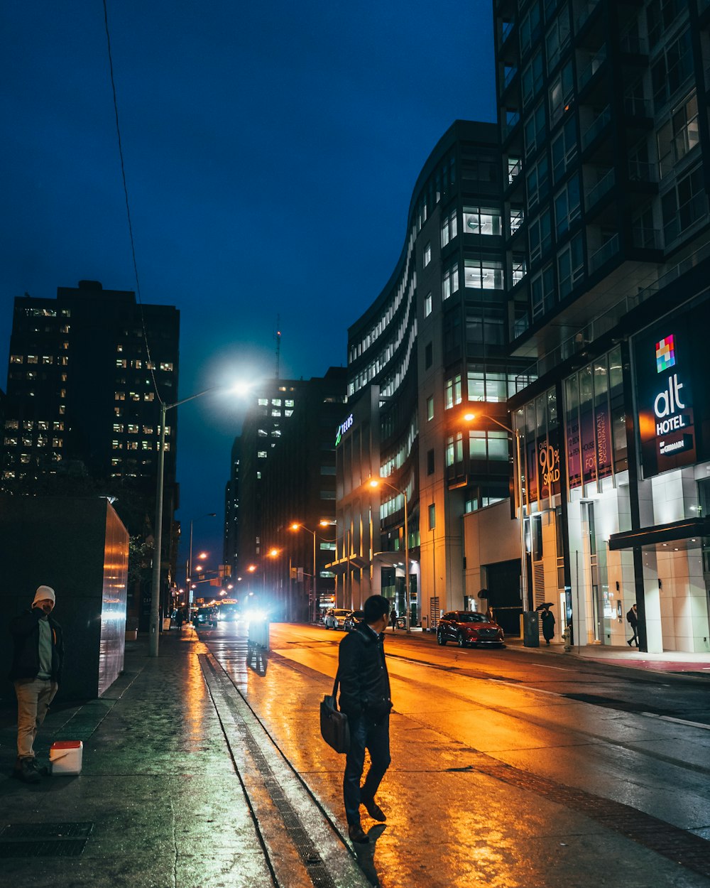 man walking on street near buildings