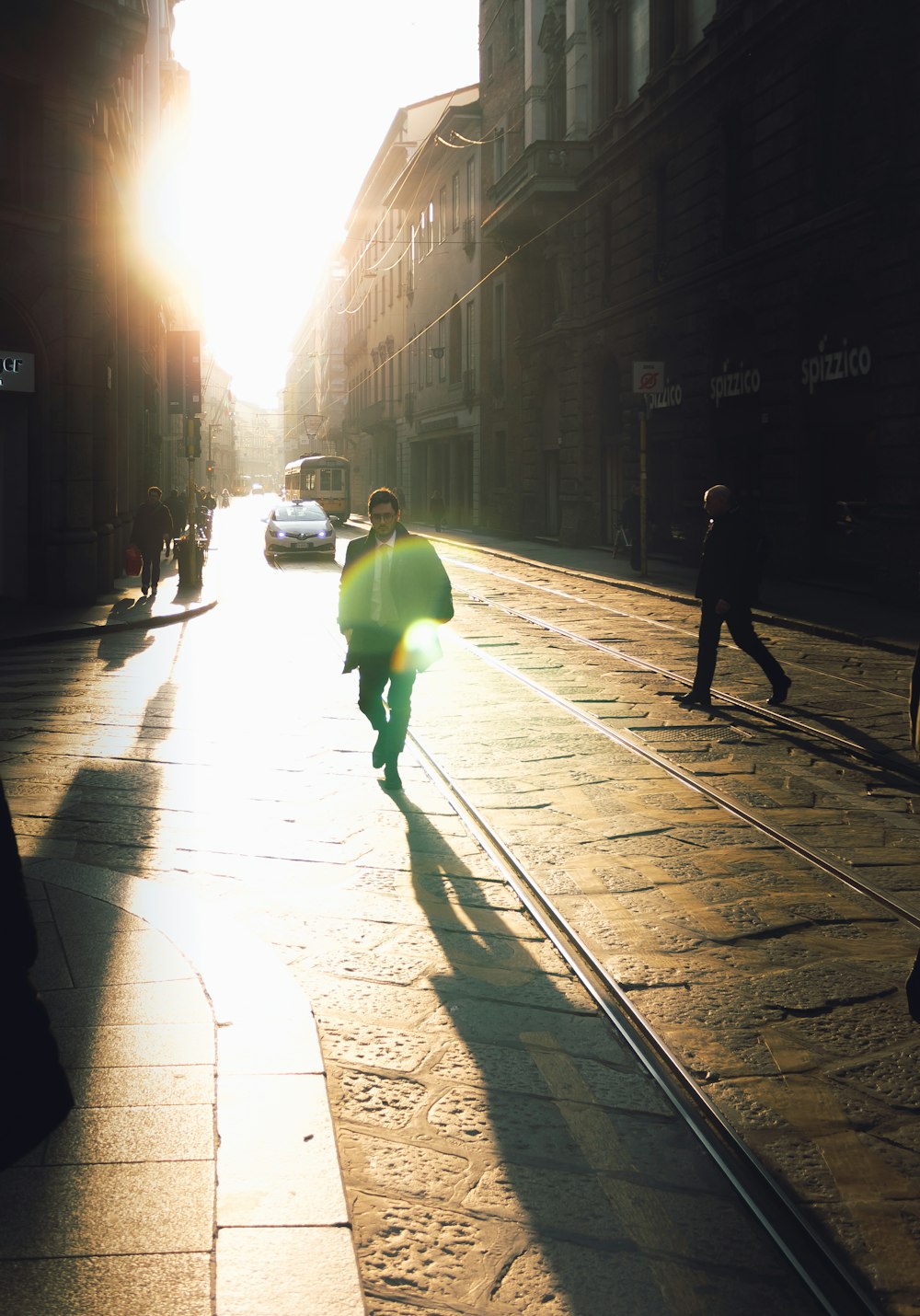 man walking on pavement road at daytime