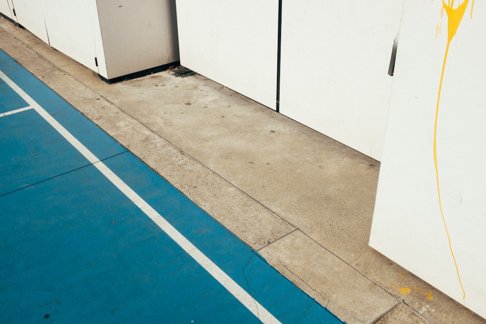 a white refrigerator sitting next to a white wall