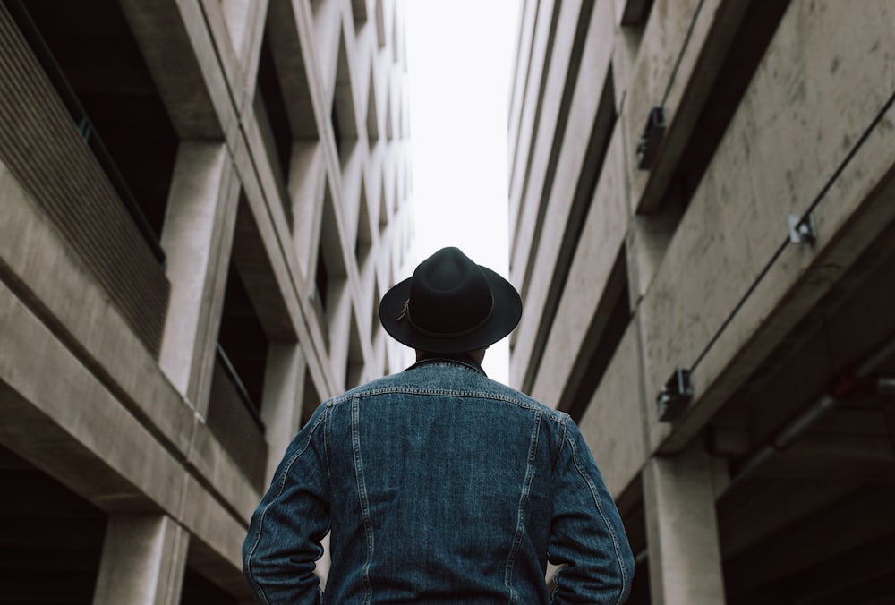 man standing between two buildings