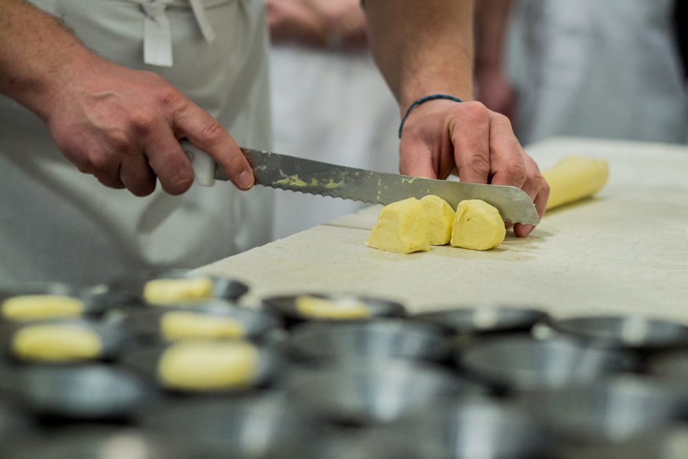 person slicing butter