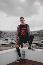 Young person customizing an oversized t-shirt on a digital platform with vibrant urban graphics.